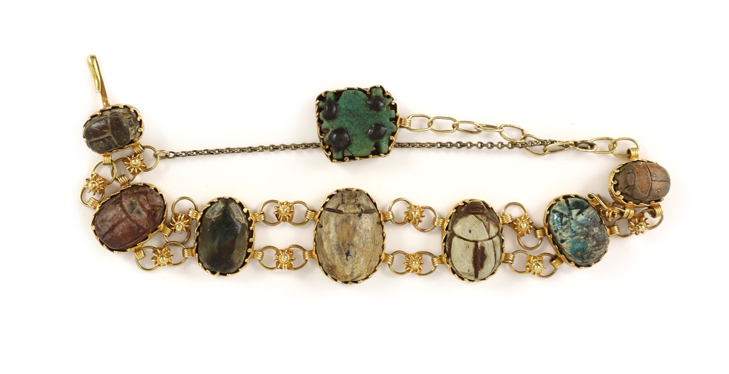 A 19th century gold and graduated seven antique stone scarab set bracelet
